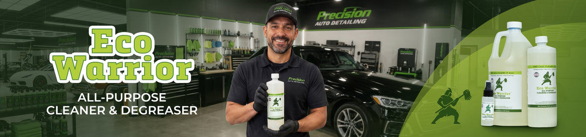 A man in a black polo shirt and cap holds a bottle of Precision Auto Detailing Eco Warrior all-purpose cleaner and degreaser in a showroom. The image is a wide promotional banner with product bottles on the right and large green text reading 'Eco Warrior' and 'ALL-PURPOSE CLEANER & DEGREASER'.